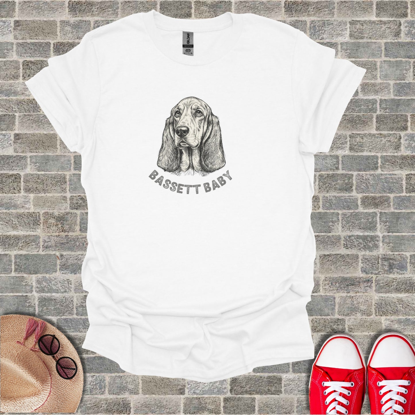 White t-shirt with a sketch of a basset hound and "BASSETT BABY" text.