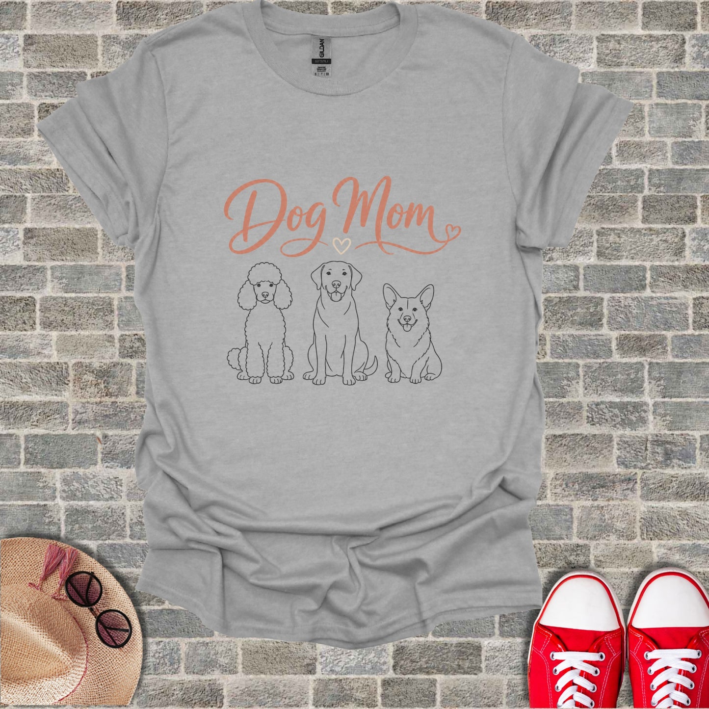 Grey t-shirt with "Dog Mom" text and line drawings of a poodle, labrador, and corgi.