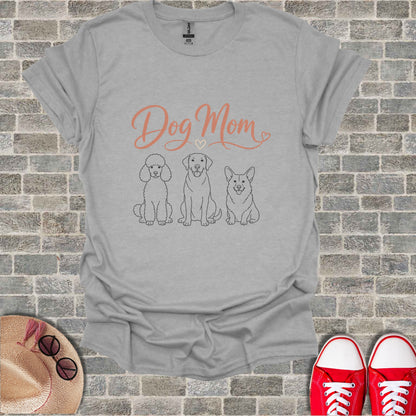 Grey t-shirt with "Dog Mom" text and line drawings of a poodle, labrador, and corgi.
