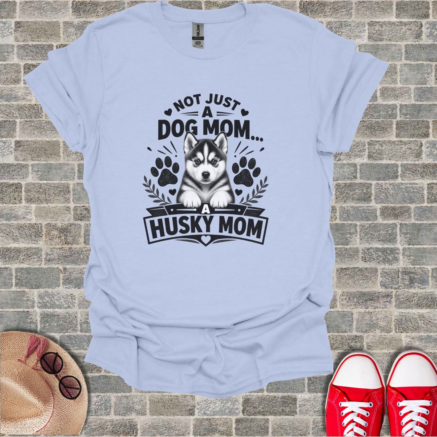 Light blue t-shirt with black graphic of a husky and text "Not Just a Dog Mom... A Husky Mom".