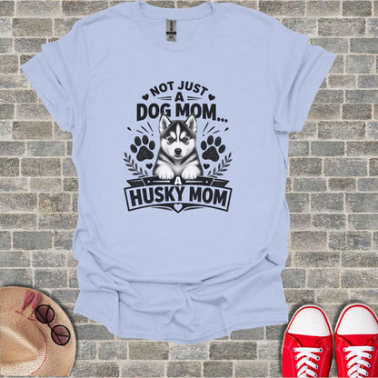 Light blue t-shirt with black graphic of a husky and text "Not Just a Dog Mom... A Husky Mom".