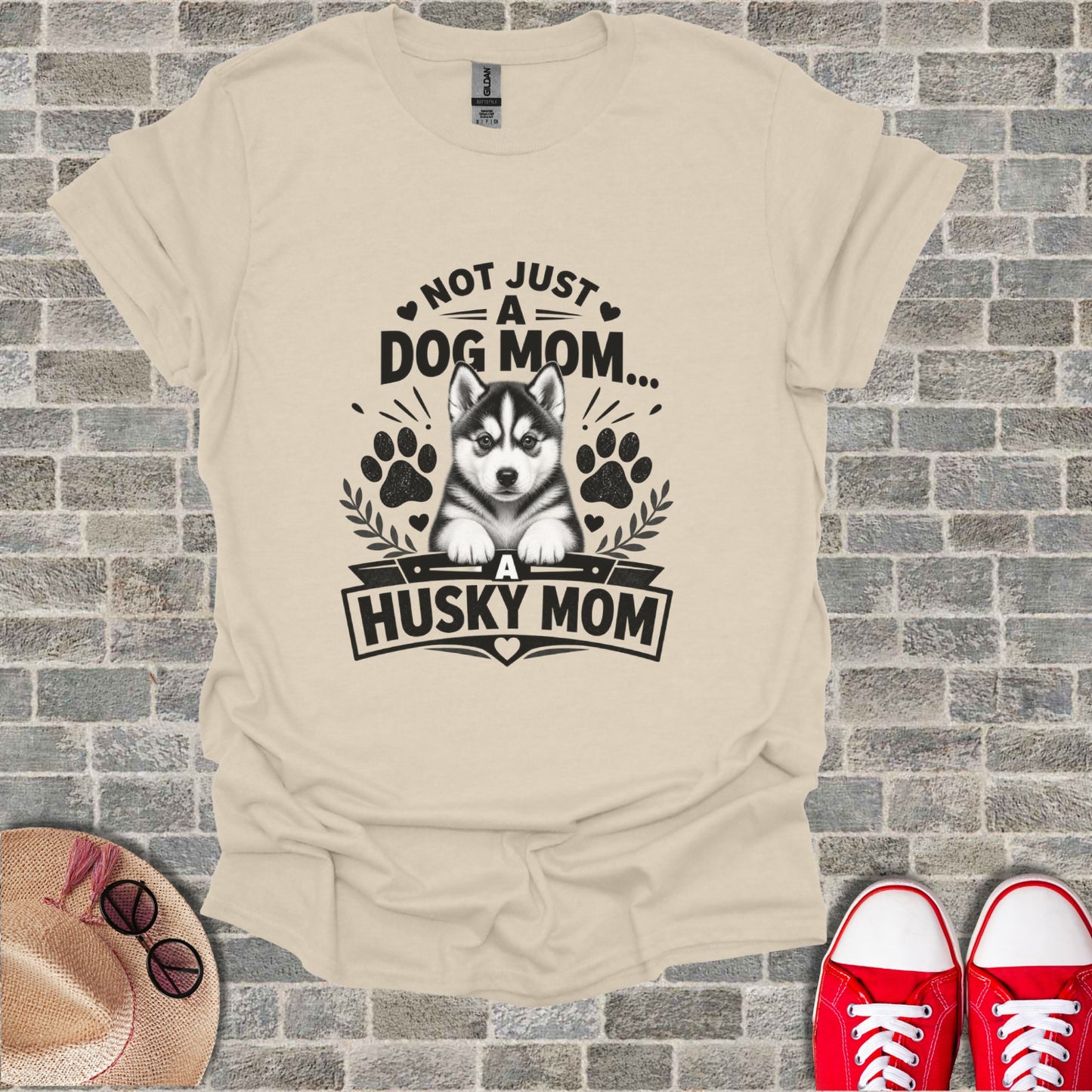 Cream t-shirt with black text and husky graphic: "Not just a dog mom... A Husky Mom".