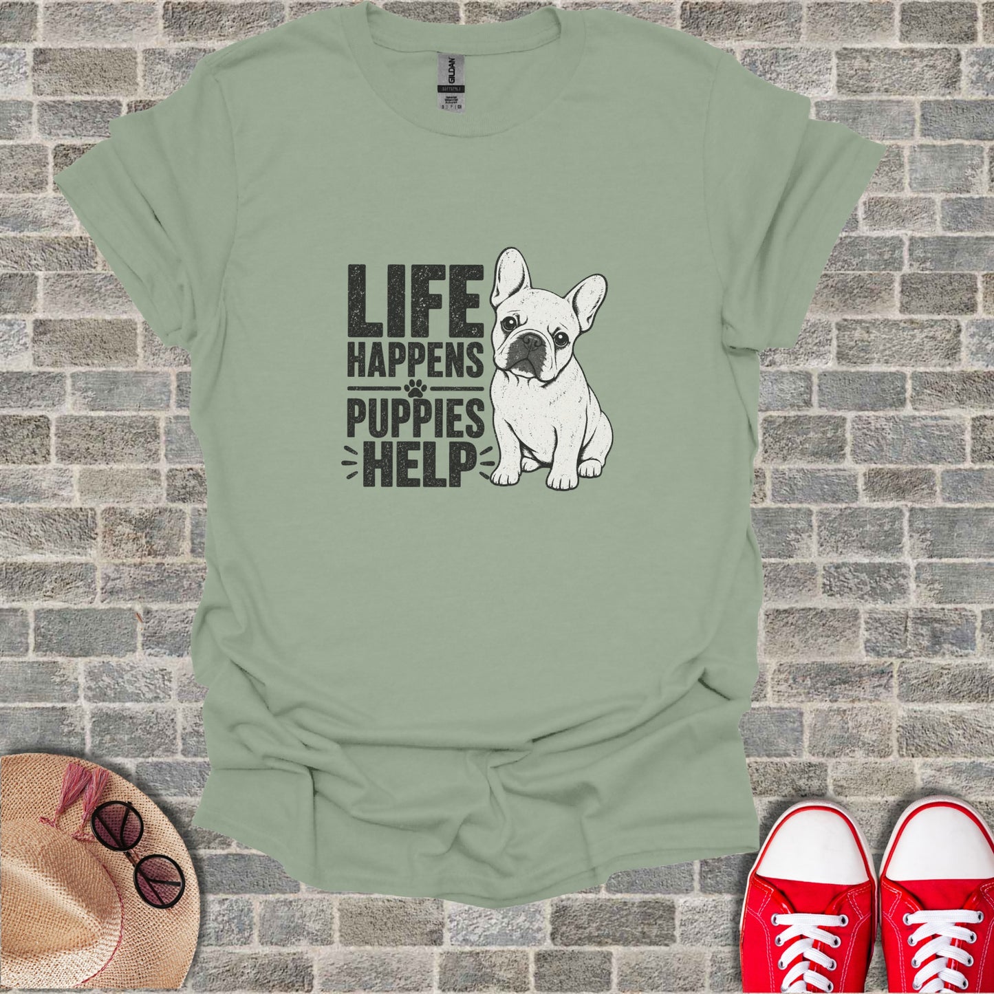 French Bulldog graphic on a light green t-shirt with text "Life Happens Puppies Help."