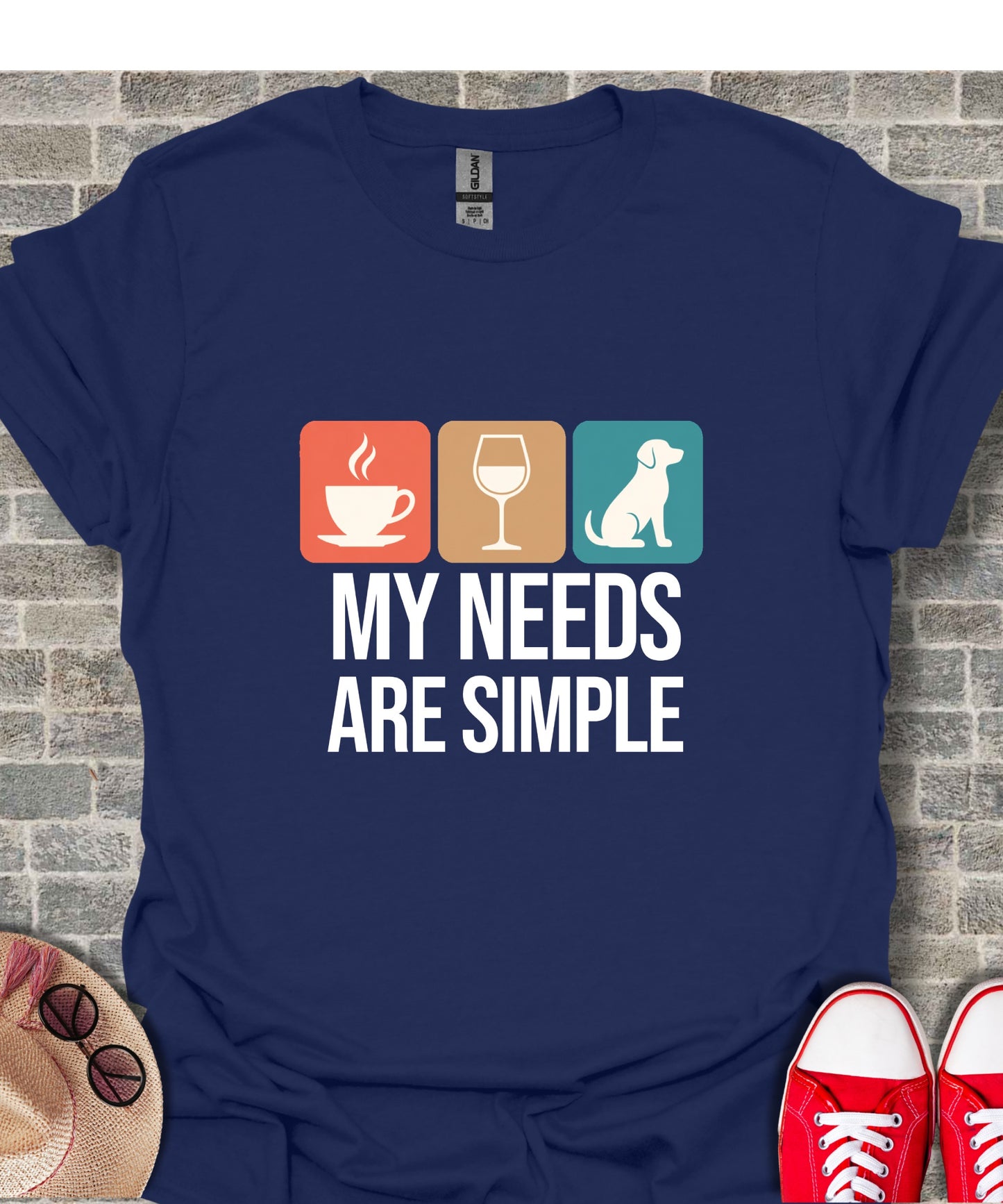 Navy t-shirt with icons for coffee, wine, dog and text "MY NEEDS ARE SIMPLE".