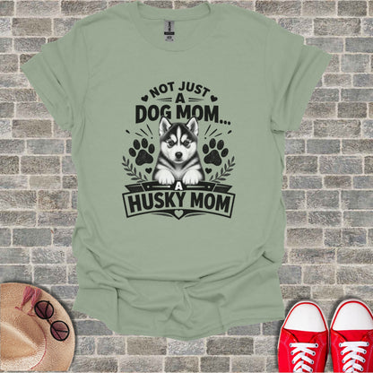 Light green t-shirt with "Not Just A Dog Mom... A Husky Mom" graphic and husky puppy.
