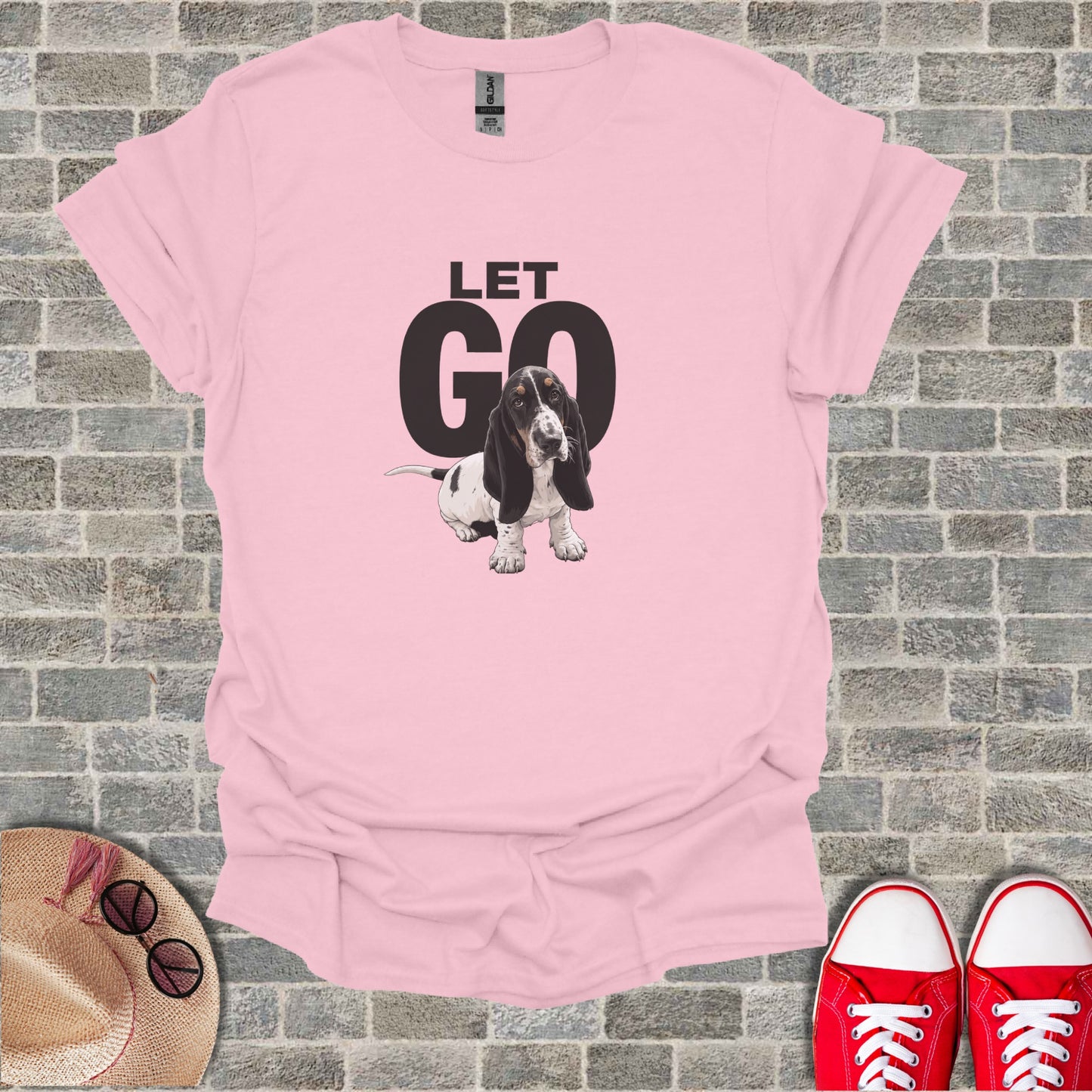 Pink t-shirt with a basset hound and the words "LET GO".