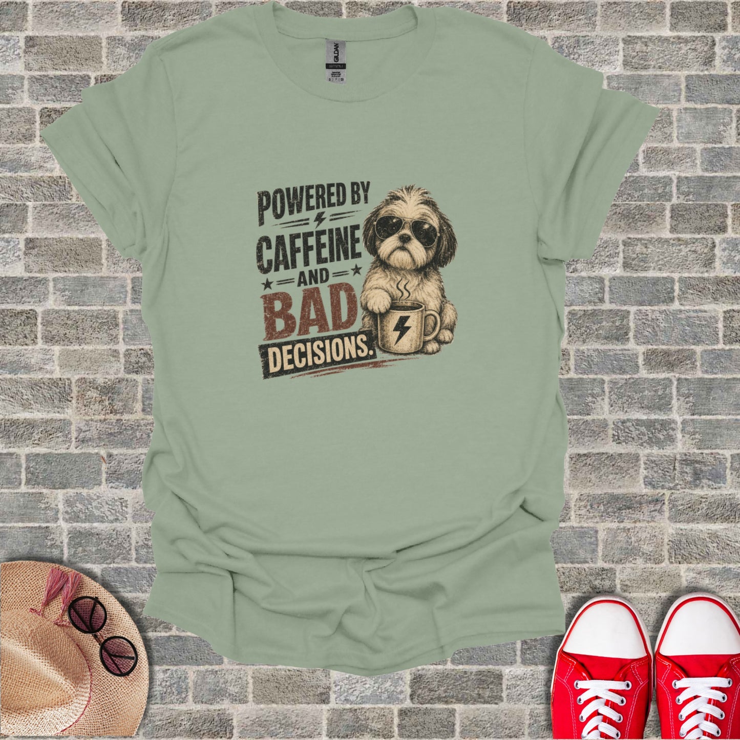T-shirt with sketch of dog wearing sunglasses holding coffee cup, text "Powered by Caffeine and Bad Decisions".