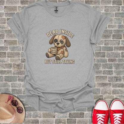 Gray t-shirt with a cartoon dog saying "DEAD INSIDE BUT STILL TRYING."
