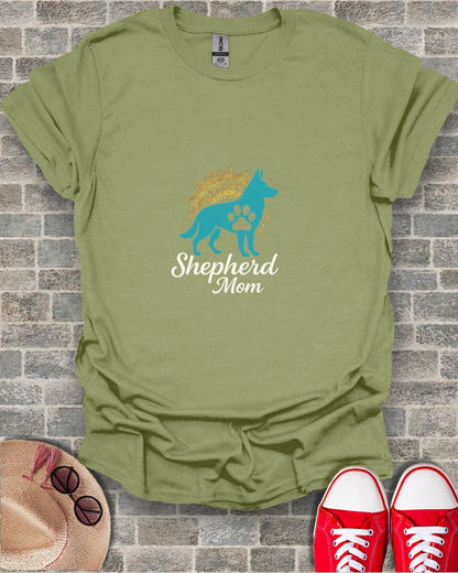Olive green t-shirt with "Shepherd Mom" and dog paw print design.