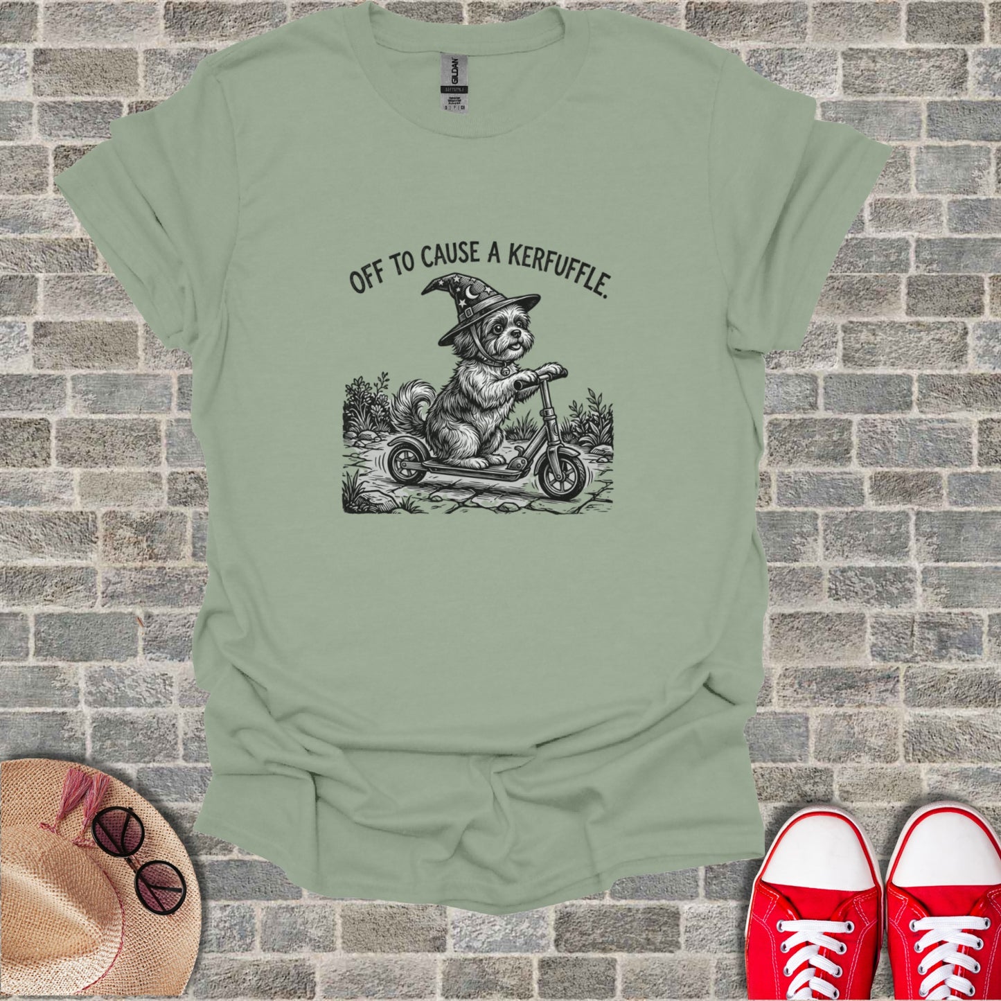 Dog in witch hat riding scooter with text "Off to cause a kerfuffle."