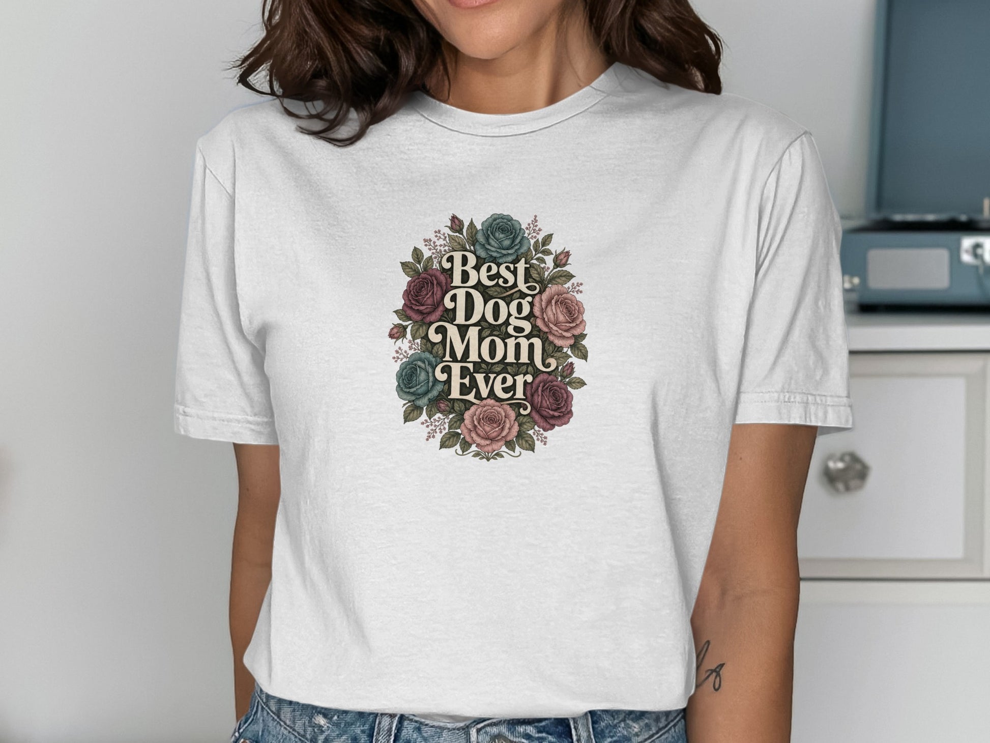 White t-shirt with "Best Dog Mom Ever" text and floral wreath design.