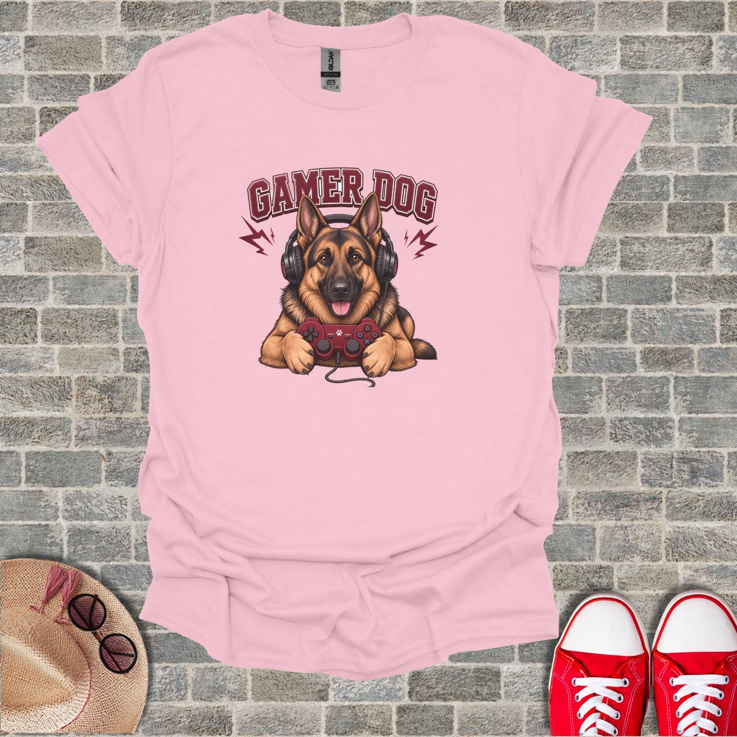 Pink t-shirt with cartoon dog wearing headphones and holding a game controller.