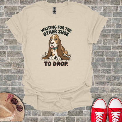 T-shirt with cartoon dog and text "Waiting for the other shoe to drop."