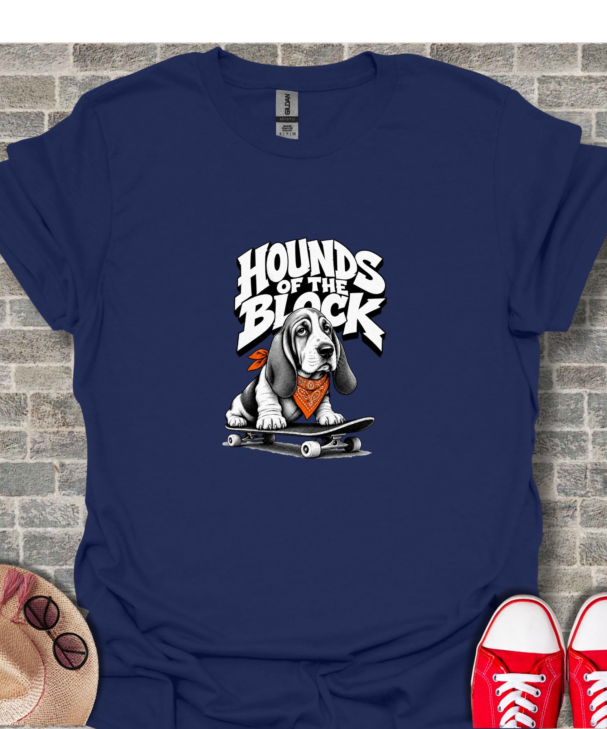 Basset hound wearing orange bandana on skateboard graphic with text "Hounds of the Block".