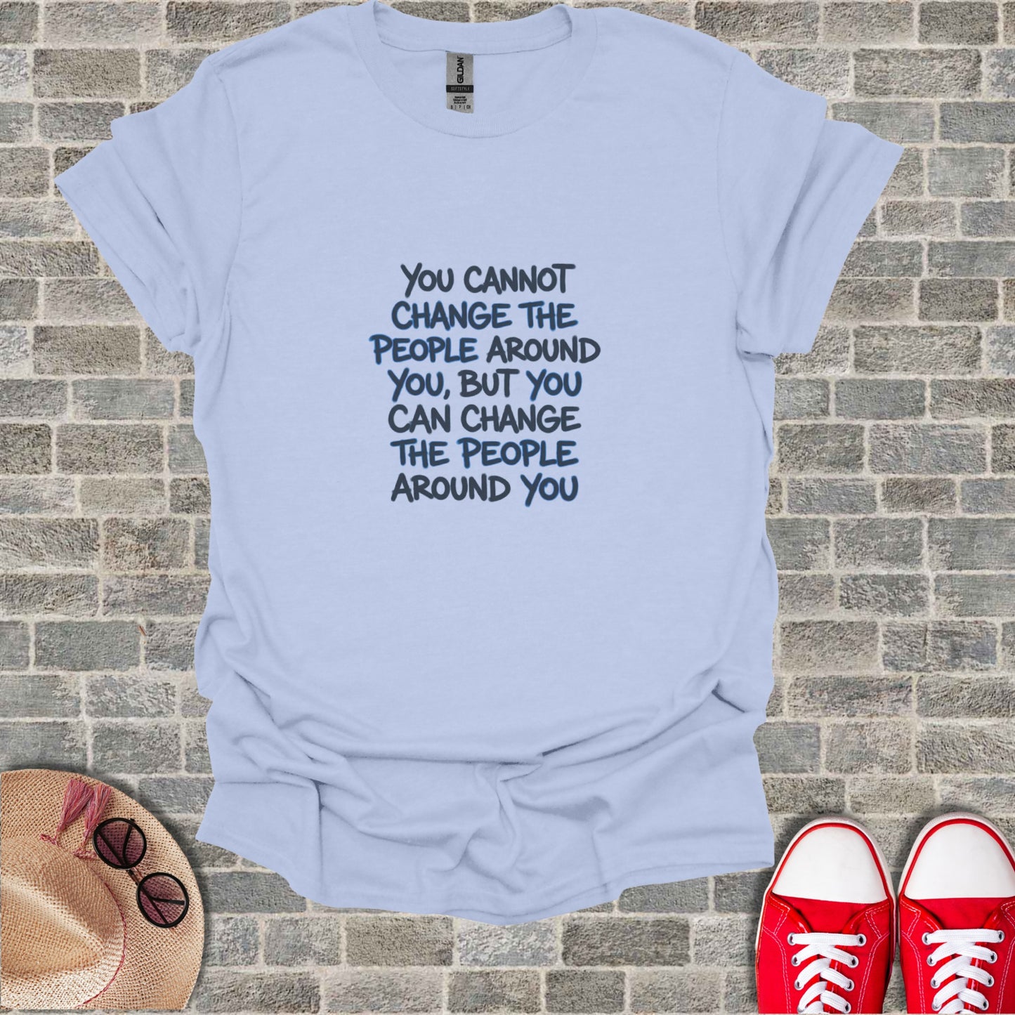 Light blue t-shirt with "You cannot change the people around you, but you can change the people around you."
