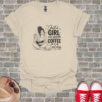 Line art illustration of a woman reading with a dog, text "Just a girl who needs coffee and dogs".