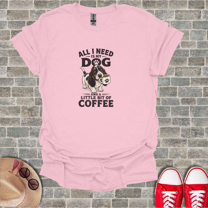 Pink t-shirt with a basset hound holding a coffee cup, text reads "All I need is my dog and a little bit of coffee."