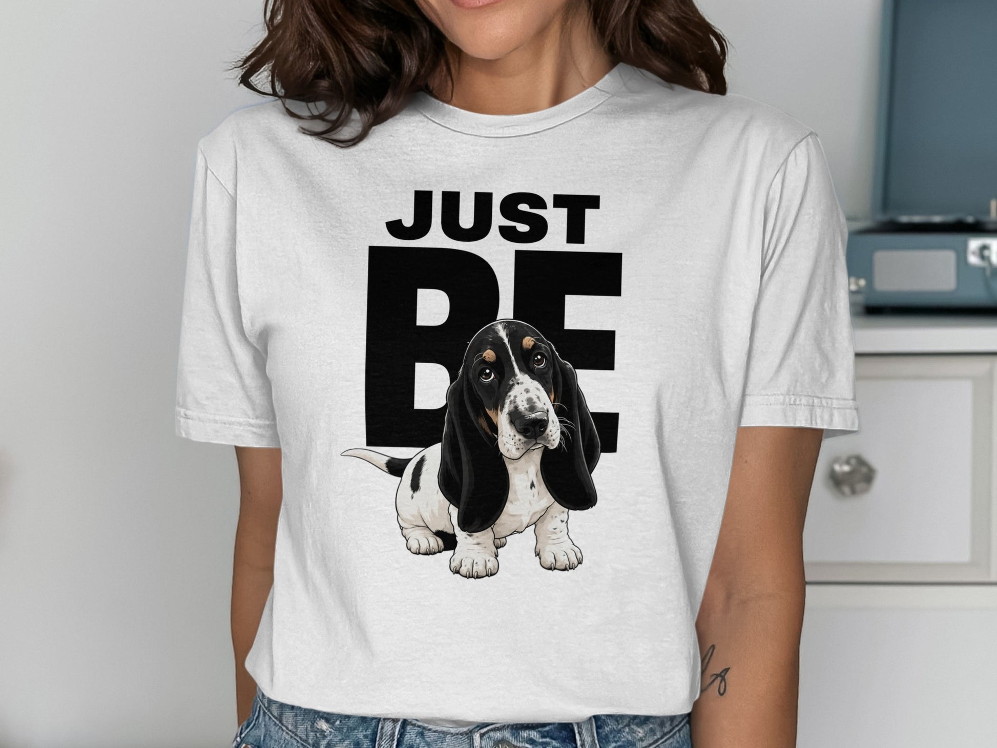 White t-shirt with "JUST BE" text and a cute basset hound puppy.