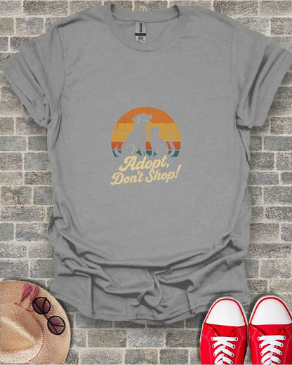 Grey t-shirt with "Adopt, Don't Shop!" slogan featuring dog and cat silhouette.