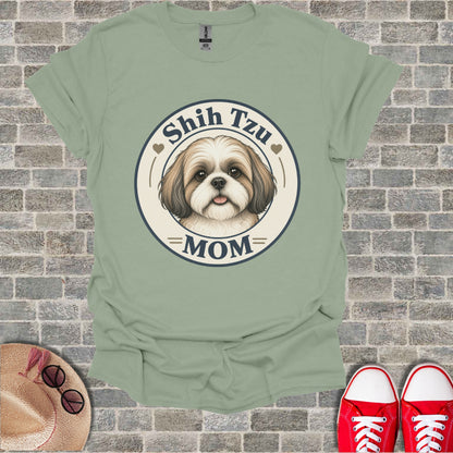Shish Tzu Mom graphic t-shirt with dog face and text on pale green shirt.