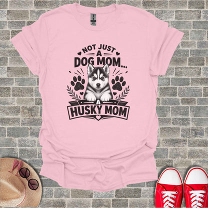 Pink t-shirt with a husky puppy graphic and text "Not Just A Dog Mom... A Husky Mom".