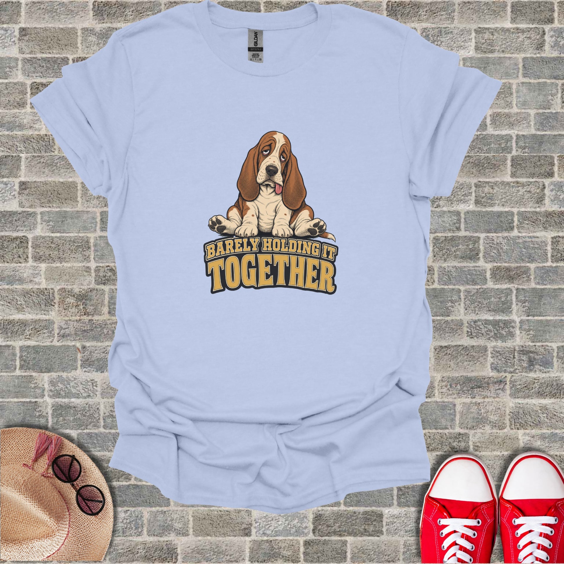 Light blue t-shirt with a sad basset hound graphic and text "BARELY HOLDING IT TOGETHER."