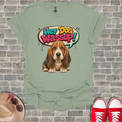 Basset hound with "Hey Dog Wassup!" speech bubble on a light green t-shirt.