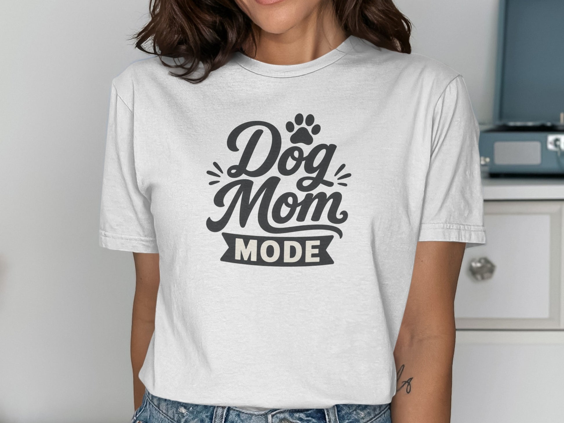 White t-shirt with "Dog Mom Mode" text and a paw print.