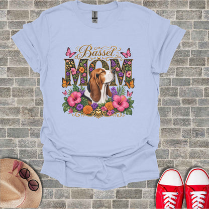 Light blue t-shirt with "Basset MOM" text and a basset hound amongst flowers and butterflies.