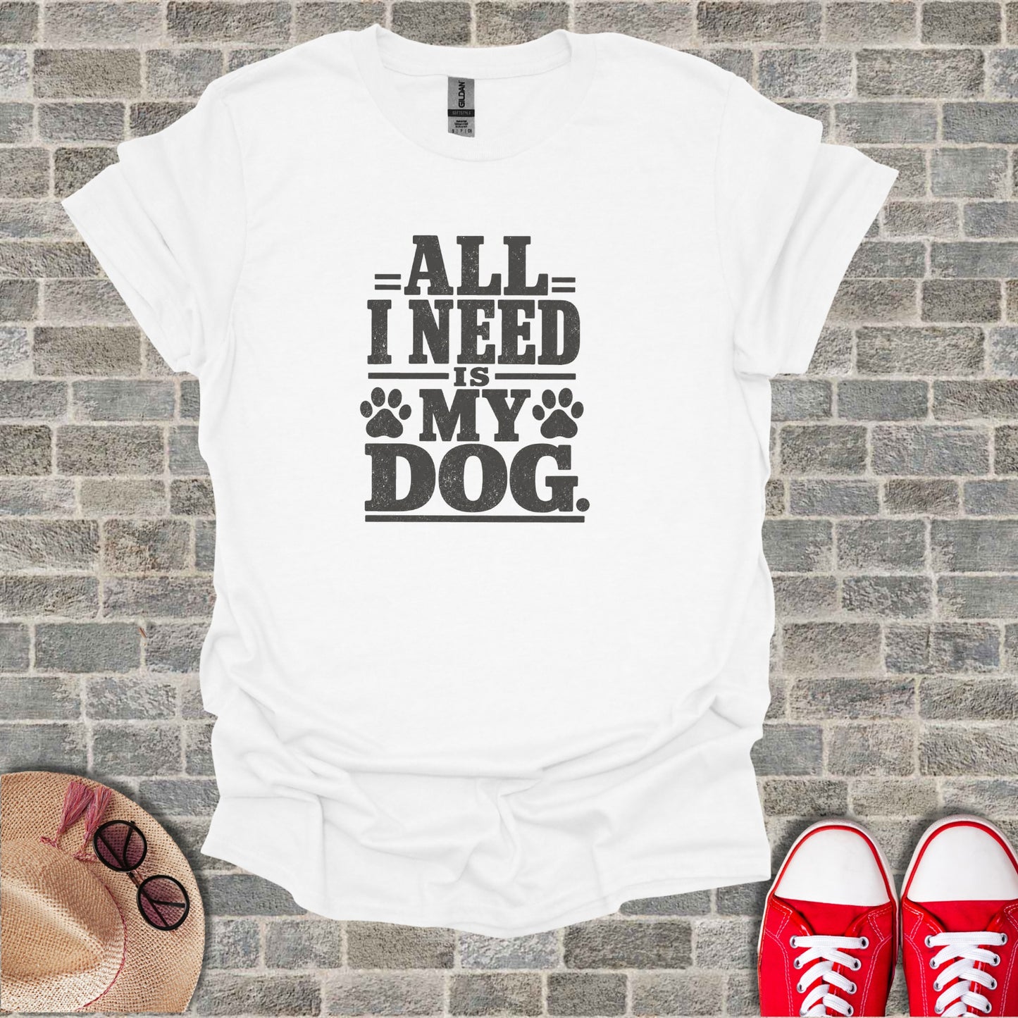 White t-shirt with "All I need is my dog" graphic.