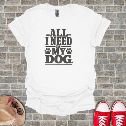 White t-shirt with "All I need is my dog" graphic.