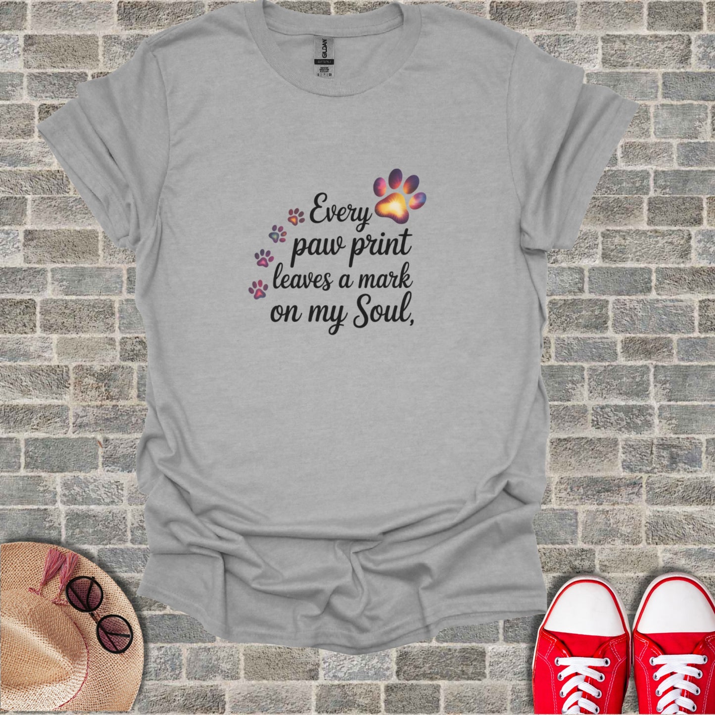 Gray t-shirt with "Every paw print leaves a mark on my Soul" text and paw prints.