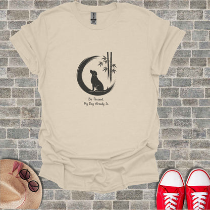 T-shirt with graphic of dog silhouette, bamboo, and text "Be Present. My Dog Already Is."