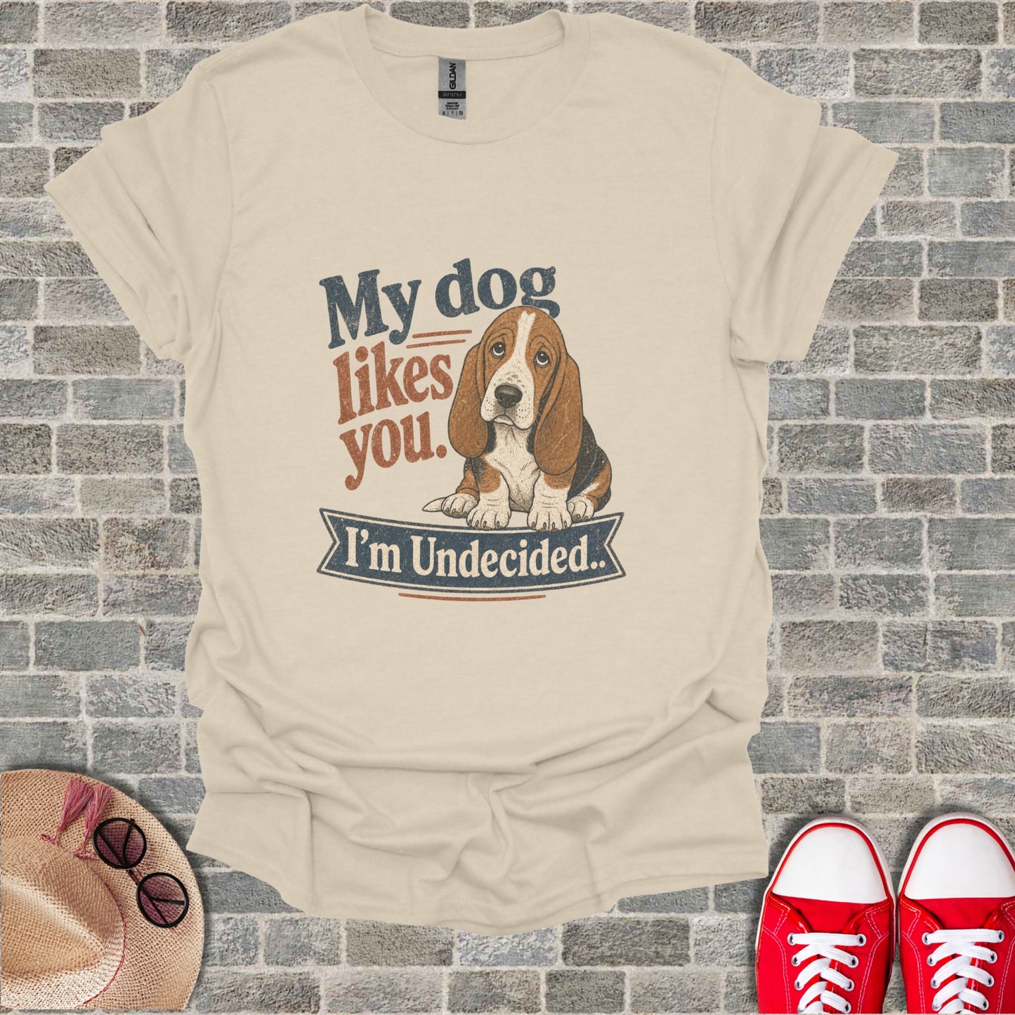 Cream t-shirt with graphic "My dog likes you. I'm Undecided." and a basset hound.