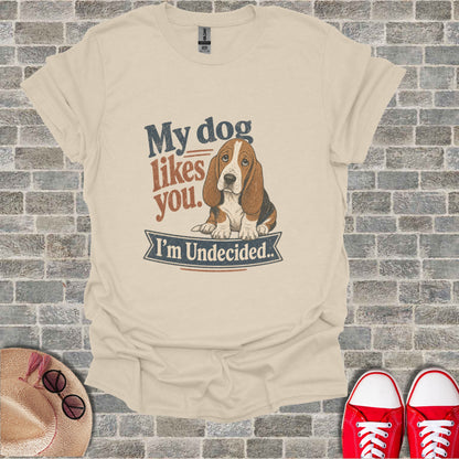 Cream t-shirt with graphic "My dog likes you. I'm Undecided." and a basset hound.