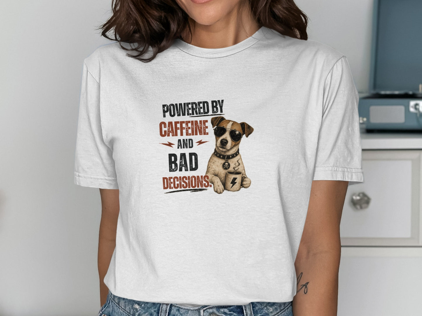 T-shirt with dog wearing sunglasses holding coffee cup, text reads "POWERED BY CAFFEINE AND BAD DECISIONS".