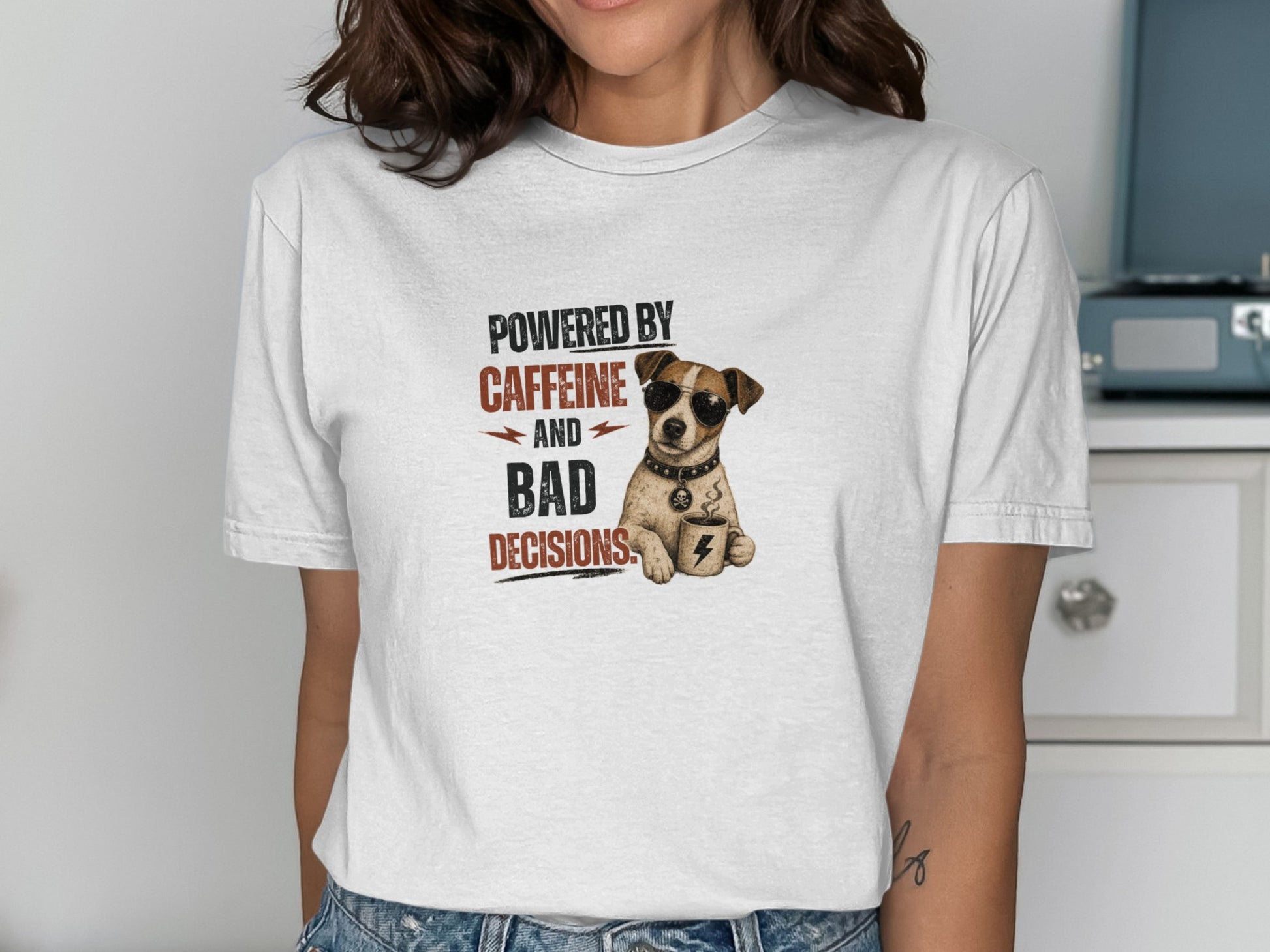 T-shirt with dog wearing sunglasses holding coffee cup, text reads "POWERED BY CAFFEINE AND BAD DECISIONS".