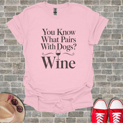 Pink t-shirt with text "You Know What Pairs With Dogs? Wine" and a wine glass graphic.