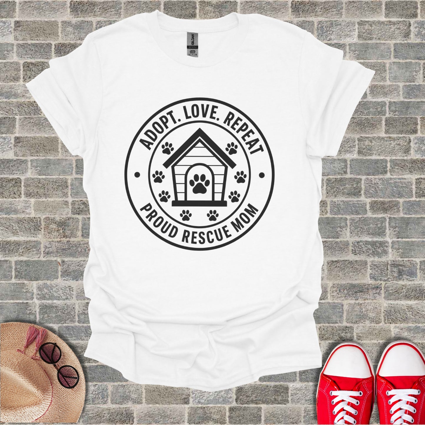 White t-shirt with "ADOPT. LOVE. REPEAT. PROUD RESCUE MOM" text and dog house graphic.