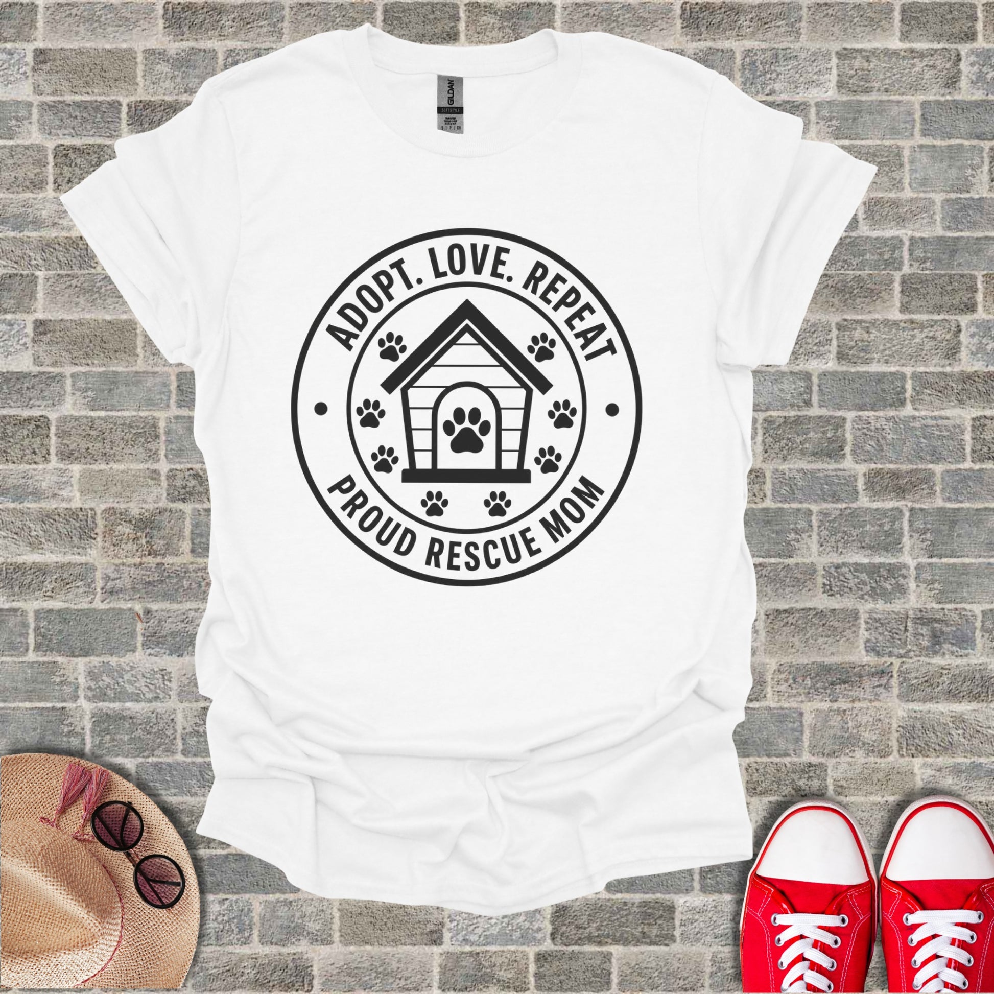 White t-shirt with "ADOPT. LOVE. REPEAT. PROUD RESCUE MOM" text and dog house graphic.