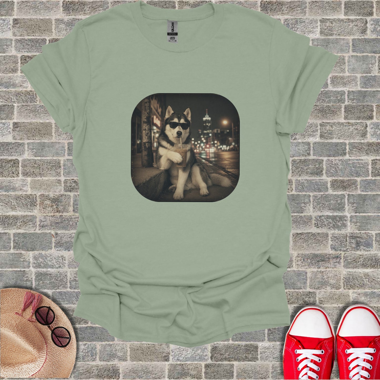 Light green t-shirt with a graphic of a husky wearing sunglasses, drinking a beverage.