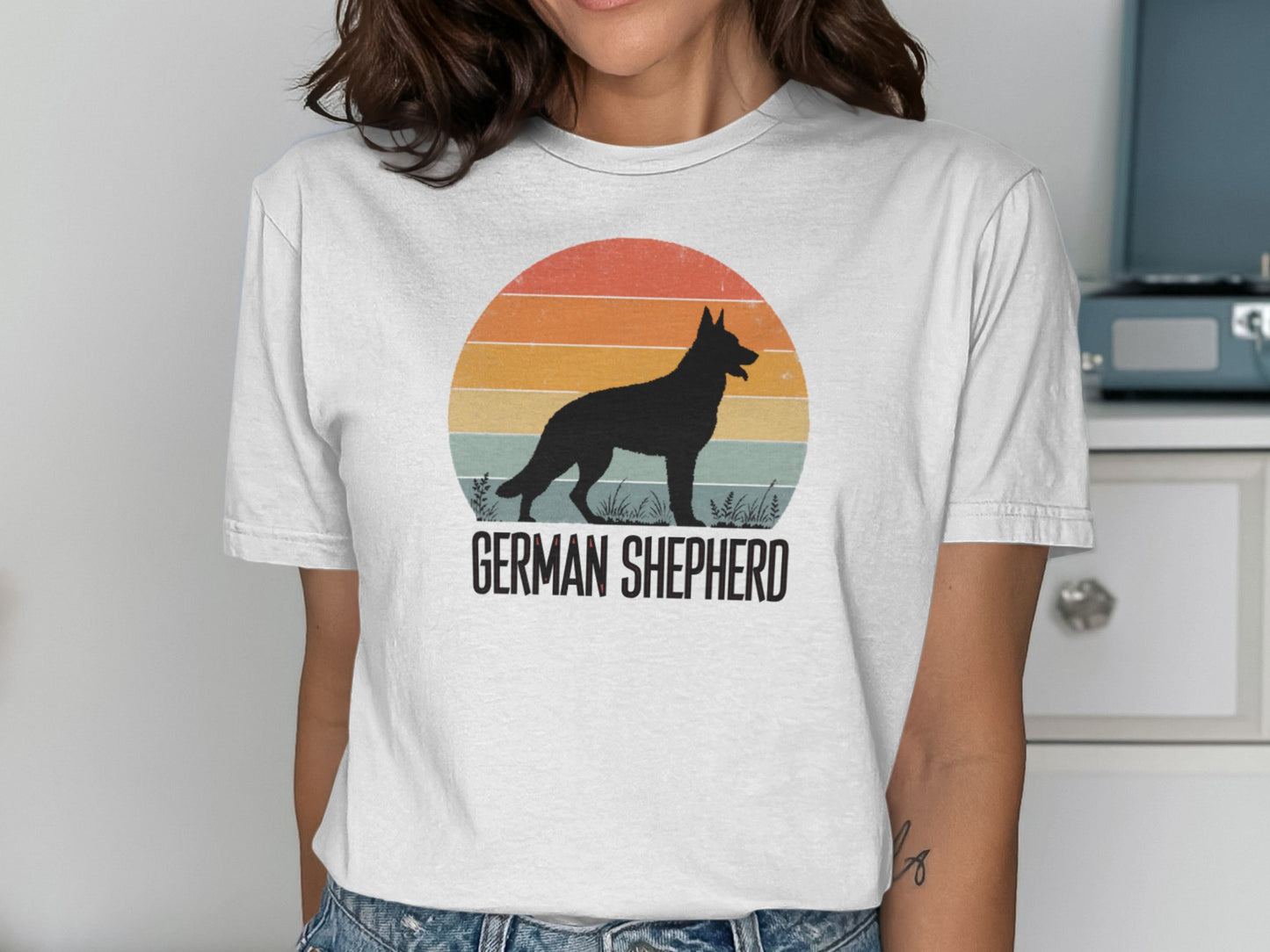 German Shepherd silhouette against a retro sunset graphic on a white t-shirt.