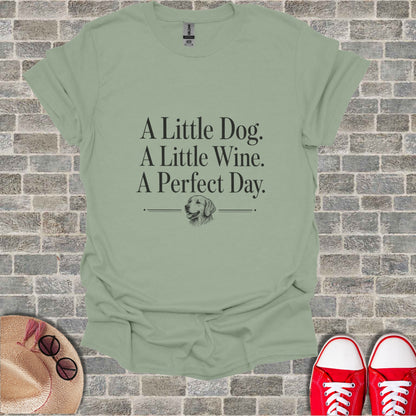 T-shirt with text "A Little Dog. A Little Wine. A Perfect Day." and dog illustration.