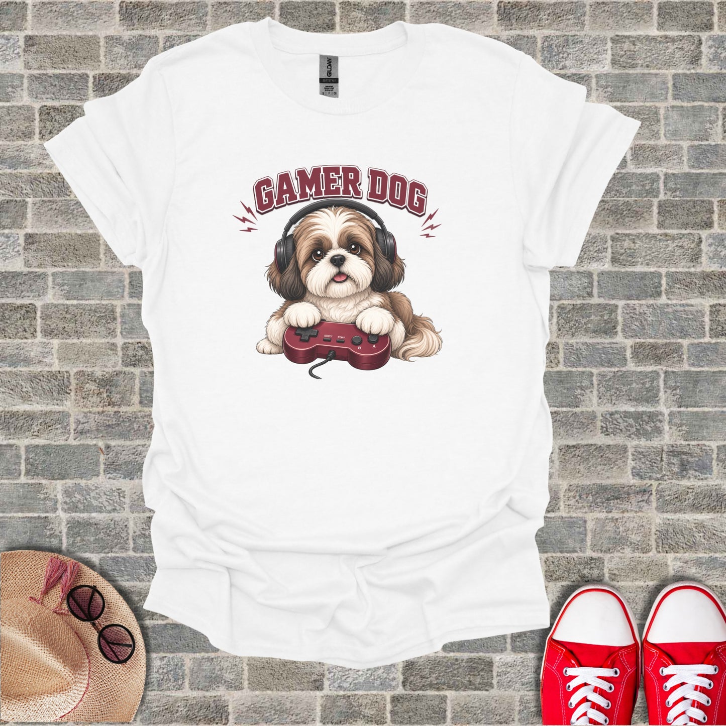 White t-shirt with cartoon gamer dog wearing headphones holding a video game controller.