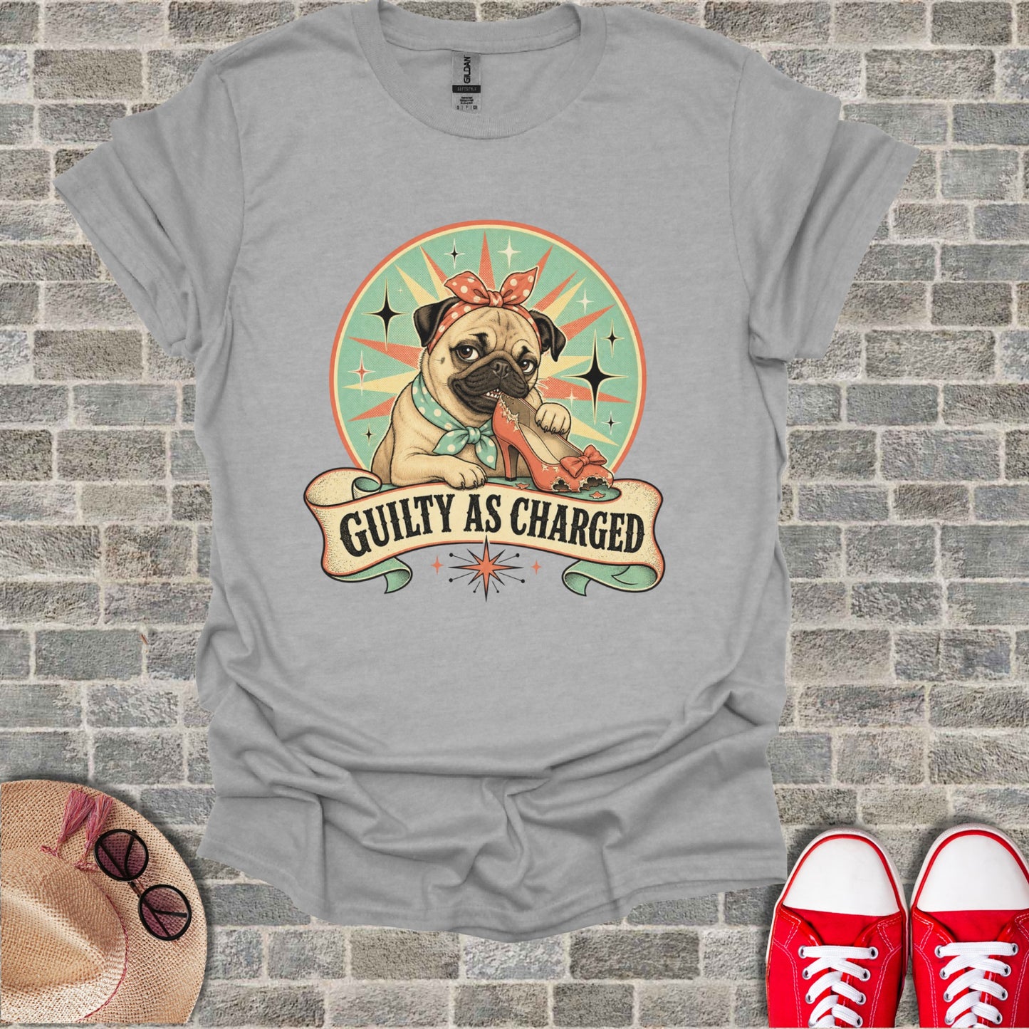 Pug wearing a bandana chews on an orange high-heeled shoe with "Guilty as Charged" text.