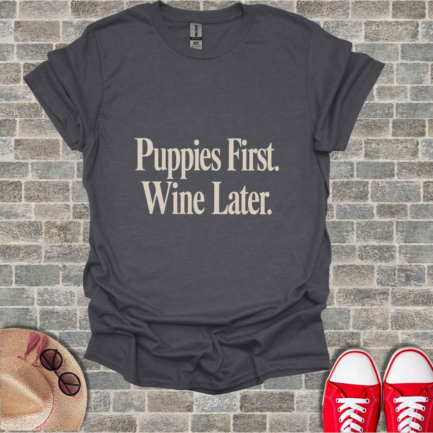 Dark grey t-shirt with "Puppies First. Wine Later." text.