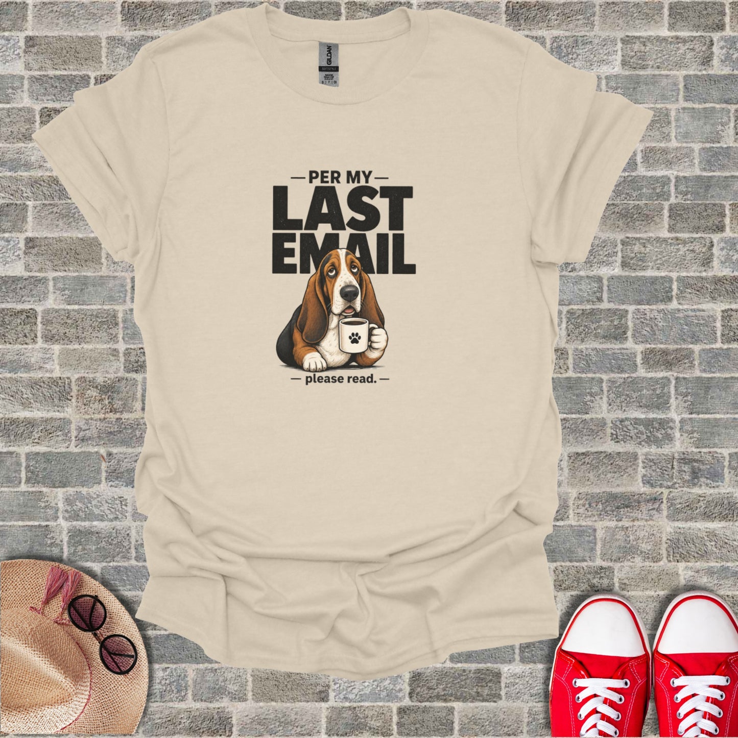Basset hound with mug and "Per my last email" text on tan t-shirt.