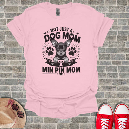Pink t-shirt with "Not Just a Dog Mom, A Min Pin Mom" text and dog graphic.