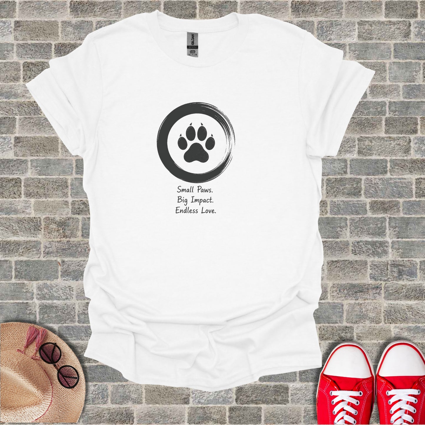 White t-shirt with a black paw print inside a circle and text.