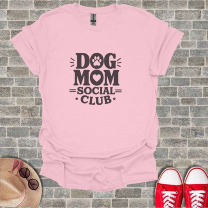 Pink t-shirt with "Dog Mom Social Club" text and paw print graphic.